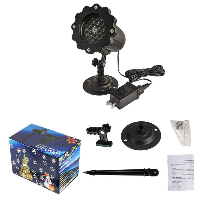 Christmas light projector with accessories on a white background