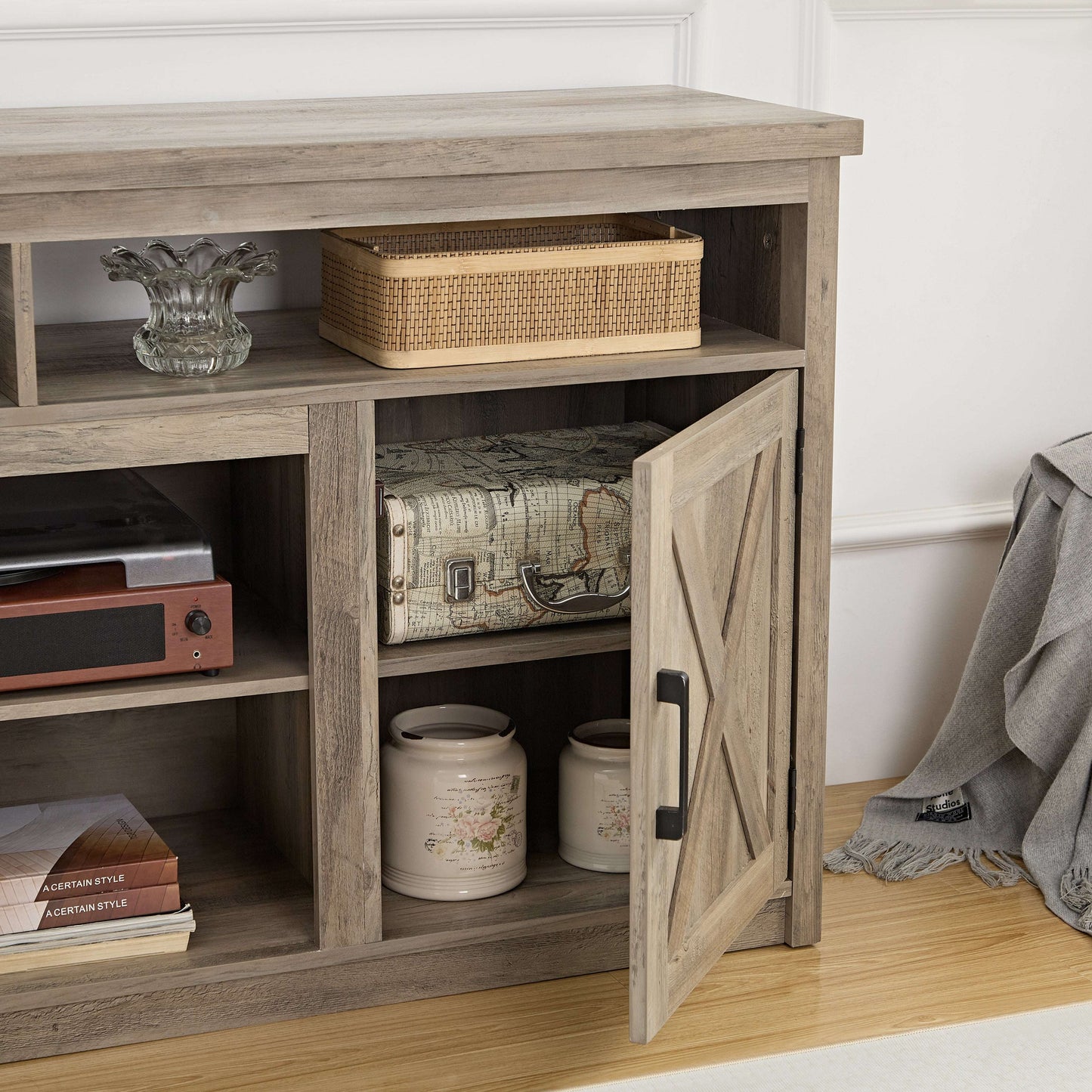 Gray wash TV stand console with barn door cabinet, shelves and woven storage bin