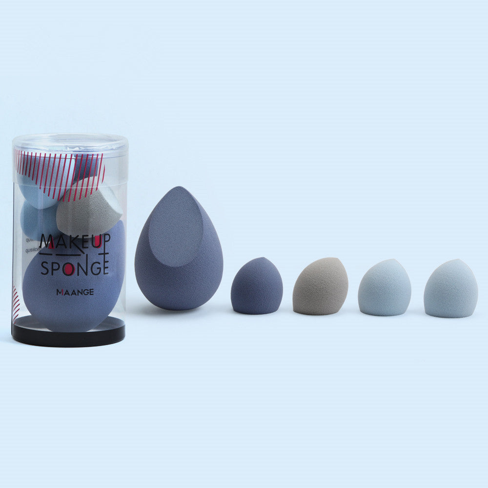 Set of makeup sponges with a cylindrical container labeled 'Makeup Sponge' on a light blue background.