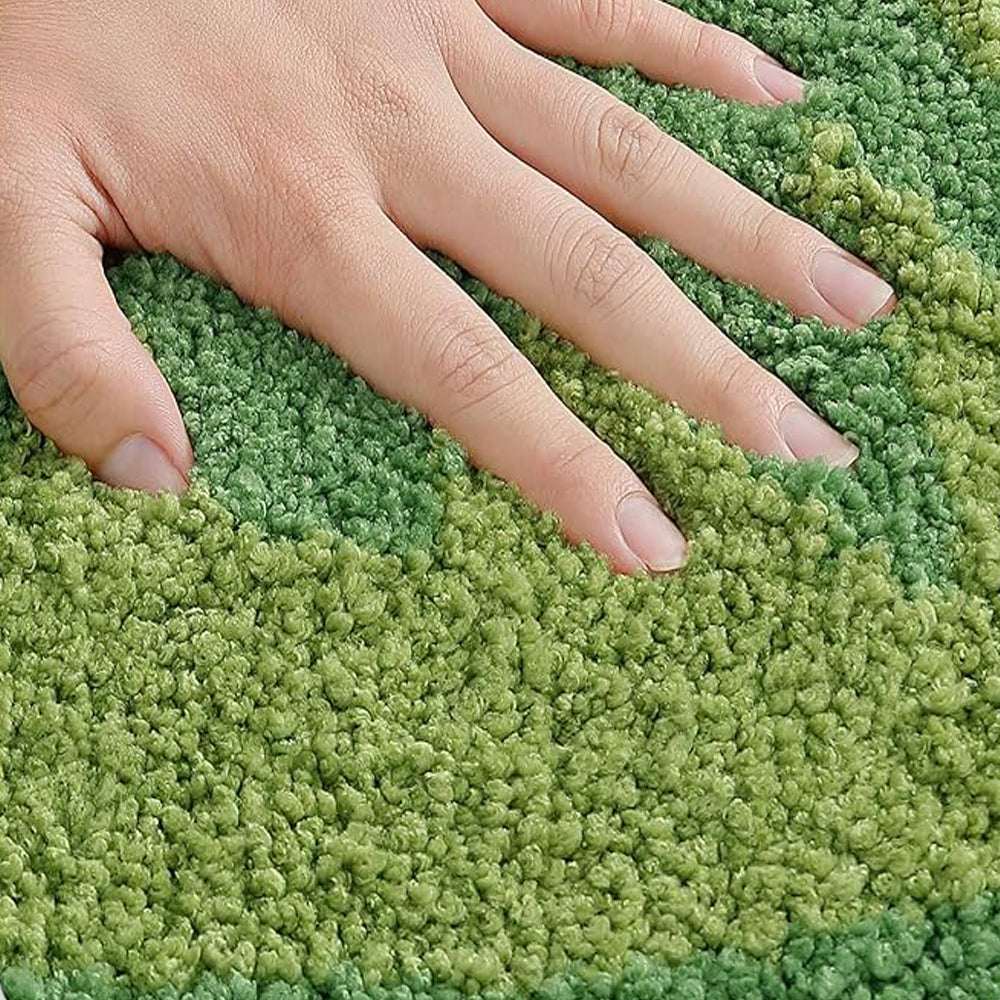 Kiwi fruit bath mat texture, green loop pile with hand touching; black seed dots