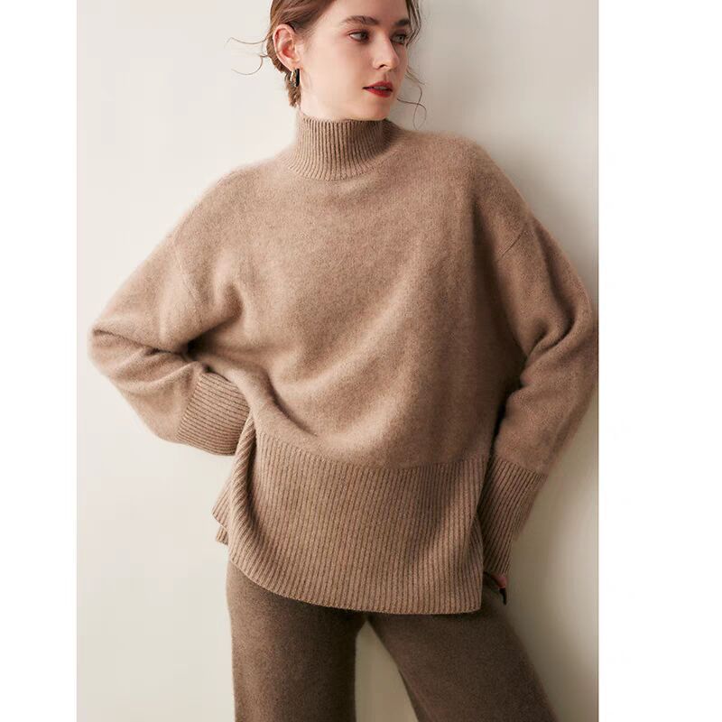 Woman wearing a brown sweater against a plain background