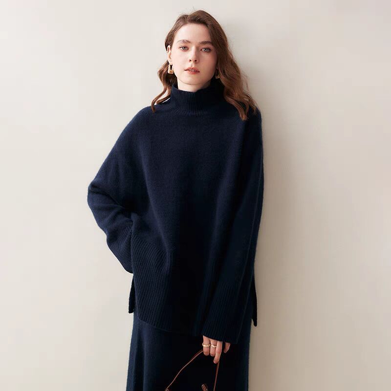 Woman wearing a dark blue sweater against a plain background