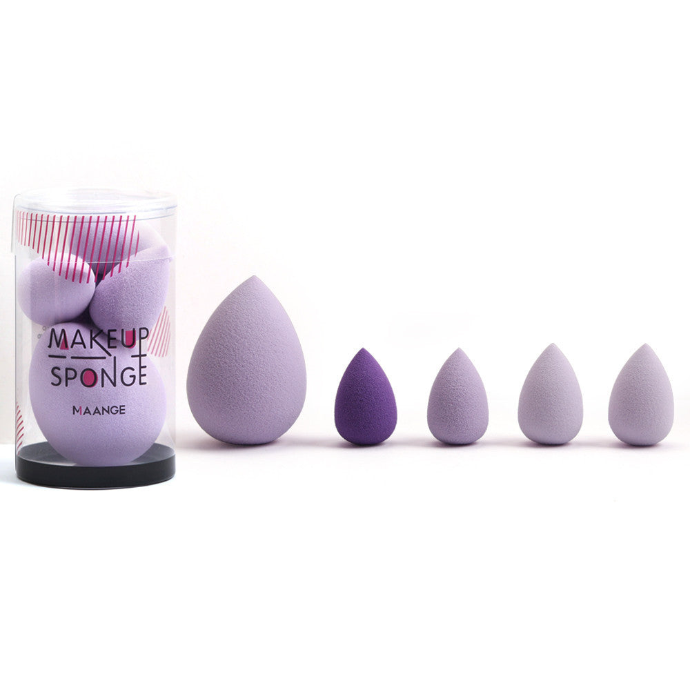 Set of purple makeup sponges with a container labeled 'Makeup Sponge' on a white background