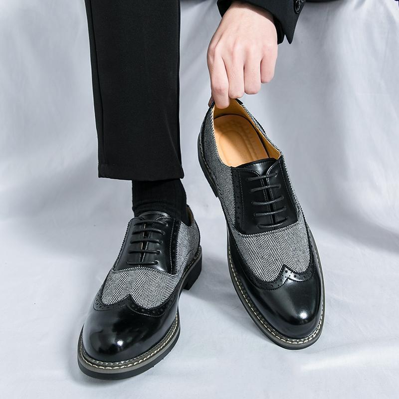 Black and gray dress shoes with a textured pattern on a white background