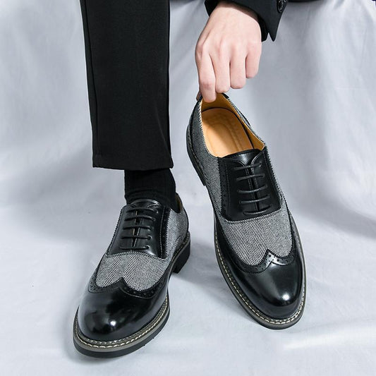 Black and gray dress shoes with a textured pattern on a white background