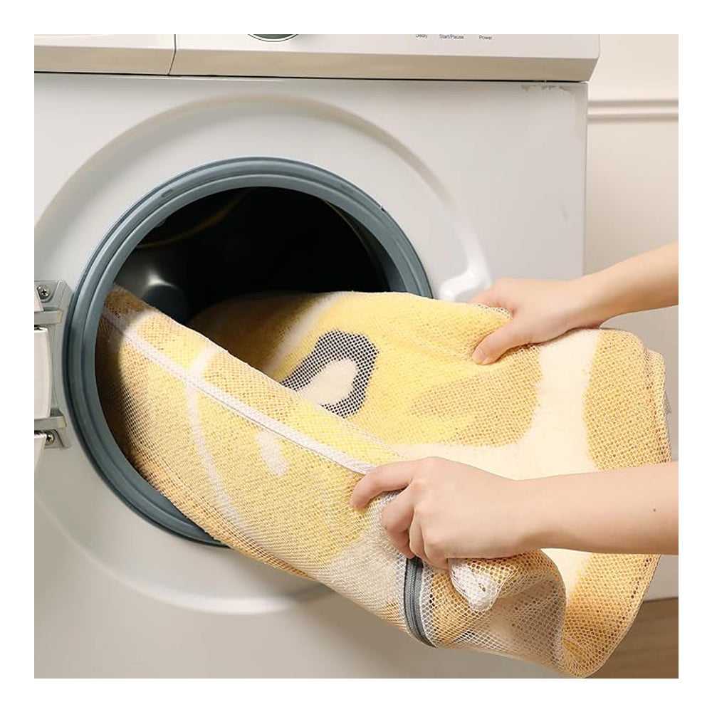 Lemon-shaped bath mat inside washing machine drum, yellow and white textured surface