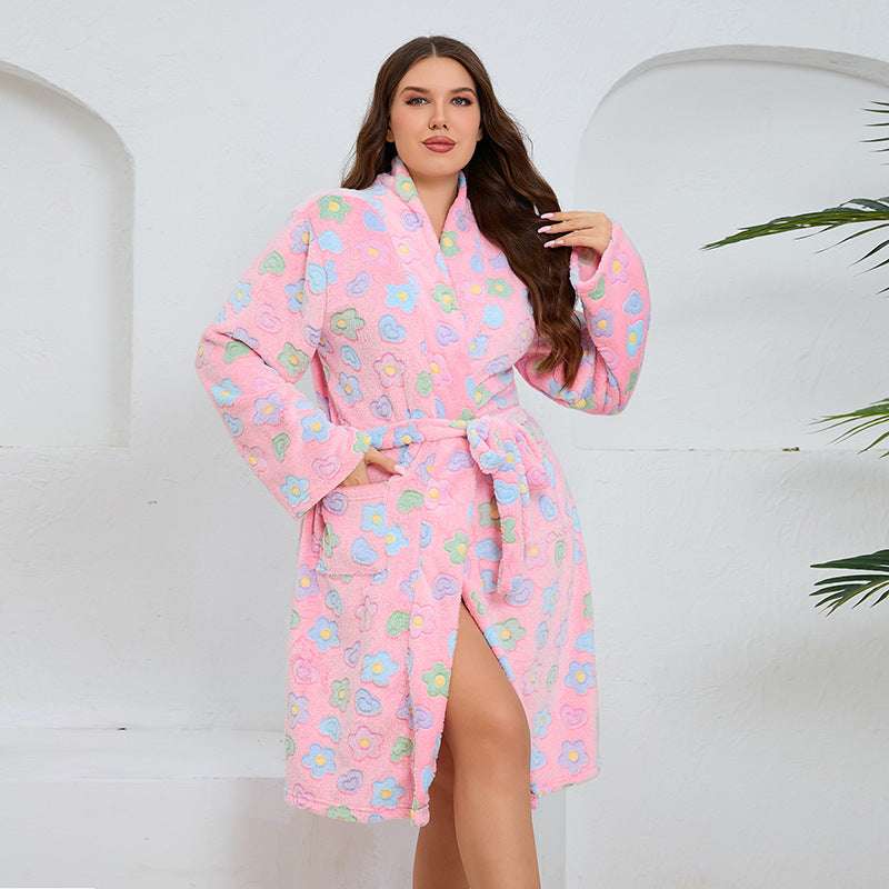 Woman wearing a pink floral robe against a white background