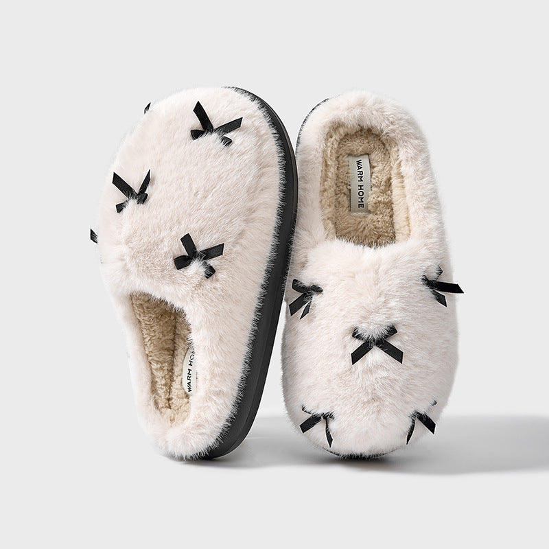 A set of women's plush home slippers with butterfly knot design. The slippers are shown in beige, white, and pink colors with a round toe and thick sole.