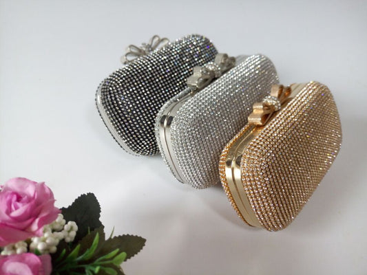 Silver and gold beaded clutch bag set with arched clasp and chain-link trim