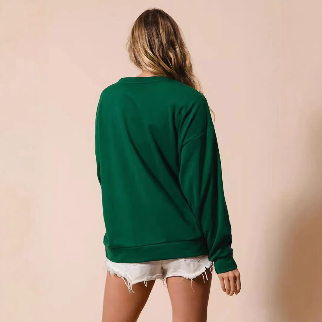 Person wearing a green sweatshirt and white shorts on a beige background