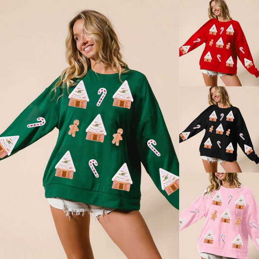 Woman wearing a green sweater with festive patterns, surrounded by other color variations.