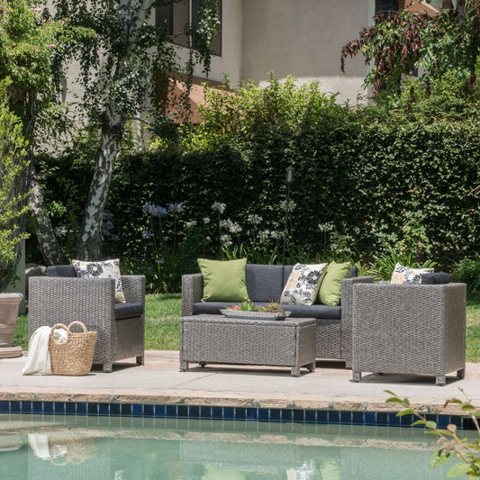 Complete Puerta 4-piece outdoor furniture set featuring a loveseat, two accent chairs, and a coffee table with weather-resistant cushions.