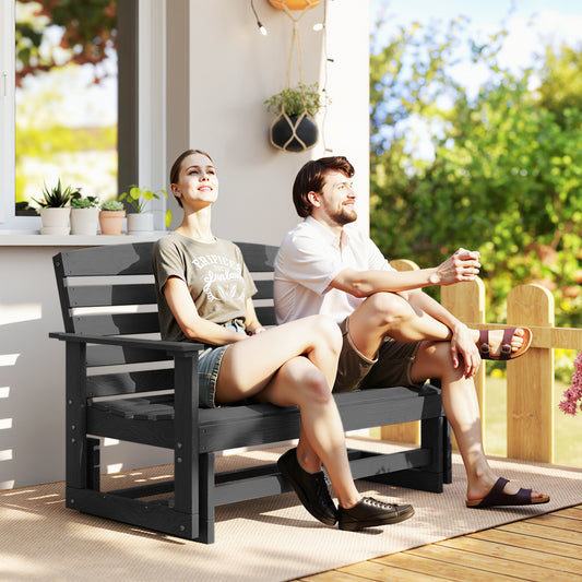 Distressed black HDPE patio glider bench with slatted design in a garden setting