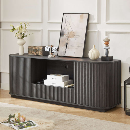 Elegant black 64-inch TV stand with a wavy rounded silhouette and vertical wood stripe texture, styled as a sideboard in a modern living room