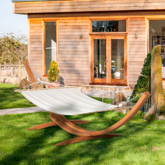Extra large white boho style hammock with a heavy-duty wooden frame stand on a green lawn