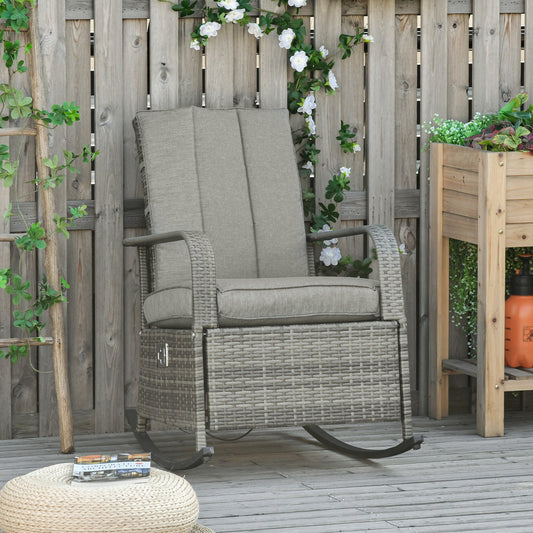Gray PE rattan outdoor recliner chair featuring a rocking base, adjustable reclining backrest, and an integrated pull-out footrest for patio lounging.