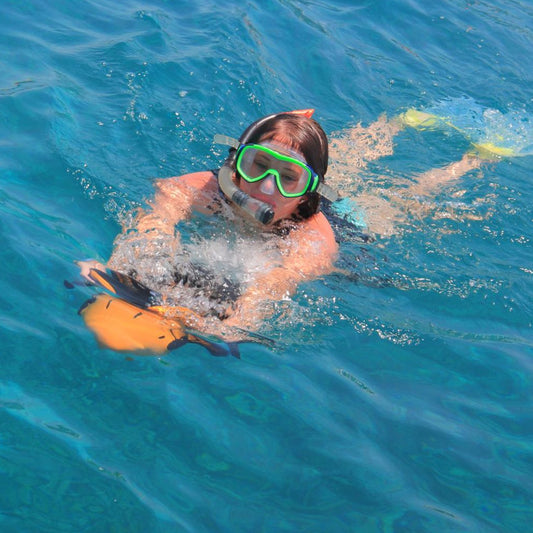 Handheld dual-propeller electric water scooter pulling a swimmer underwater, featuring a sleek aerodynamic design and integrated GoPro mount.