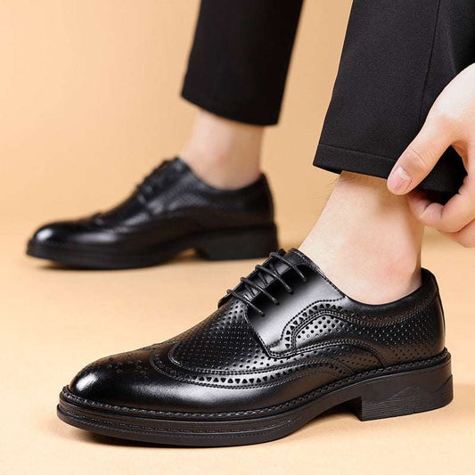 Black leather dress shoes being worn on a beige background