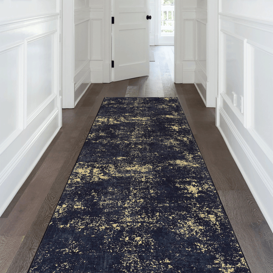 Long washable runner rug with a geometric black and gold pattern, measuring 2 feet 6 inches by 10 feet, perfect for modern kitchen or hallway floors.