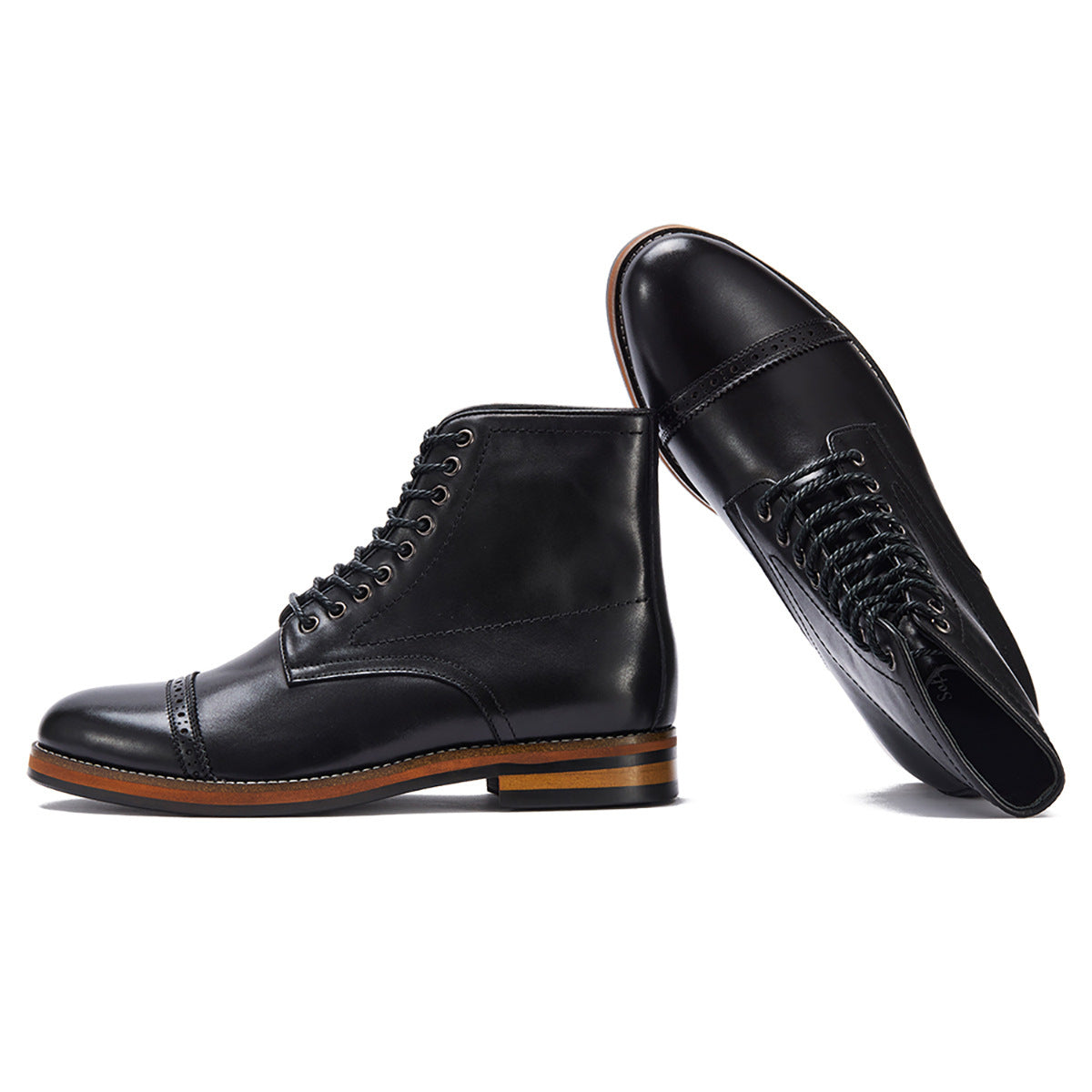 Pair of black leather boots on a white background