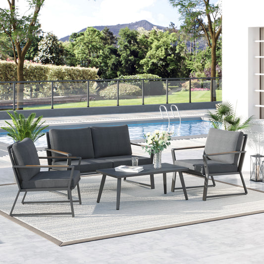 Modern dark grey 4-piece aluminum patio furniture set with a loveseat, two armchairs, and a center coffee table on a luxury terrace
