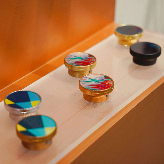 Colorful bottle caps on a wooden surface with an orange wall in the background