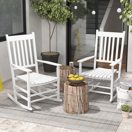 Set of classic white wooden rocking chairs featuring high slatted backs and curved armrests, perfect for outdoor porch or patio seating.