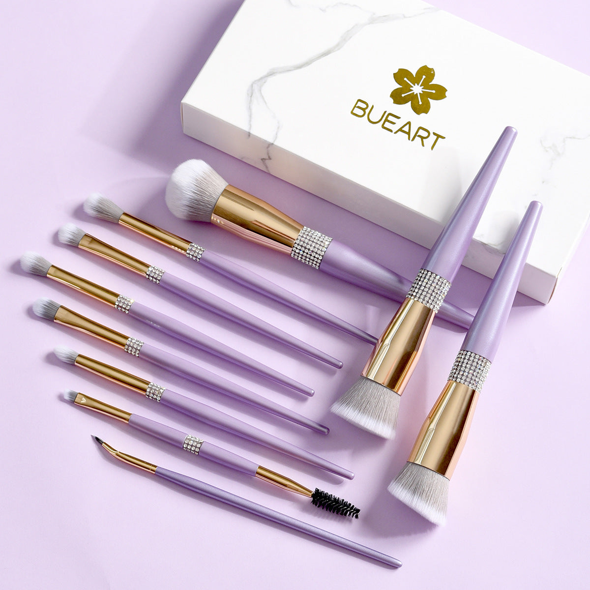 Set of makeup brushes with gold accents on a light purple background, featuring the BUEART brand.
