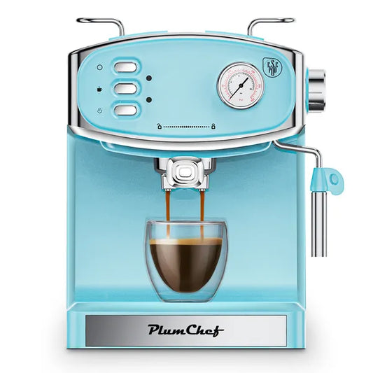 Stainless steel compact espresso machine with a pressure gauge and steam wand, brewing a fresh cup of coffee with rich crema