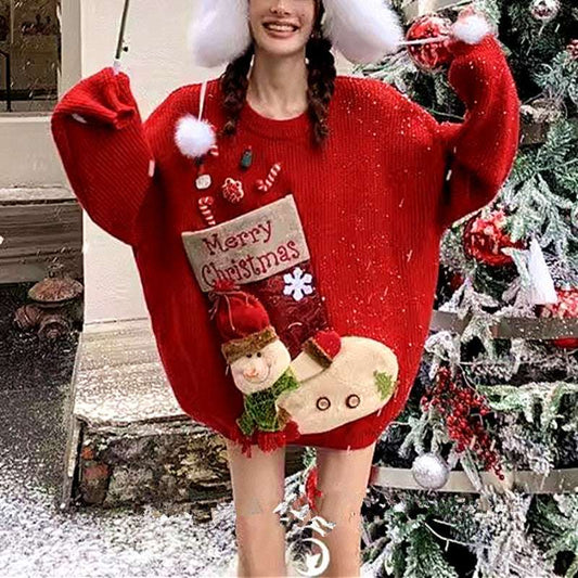 Person wearing a red Christmas sweater with festive designs in front of a decorated Christmas tree.