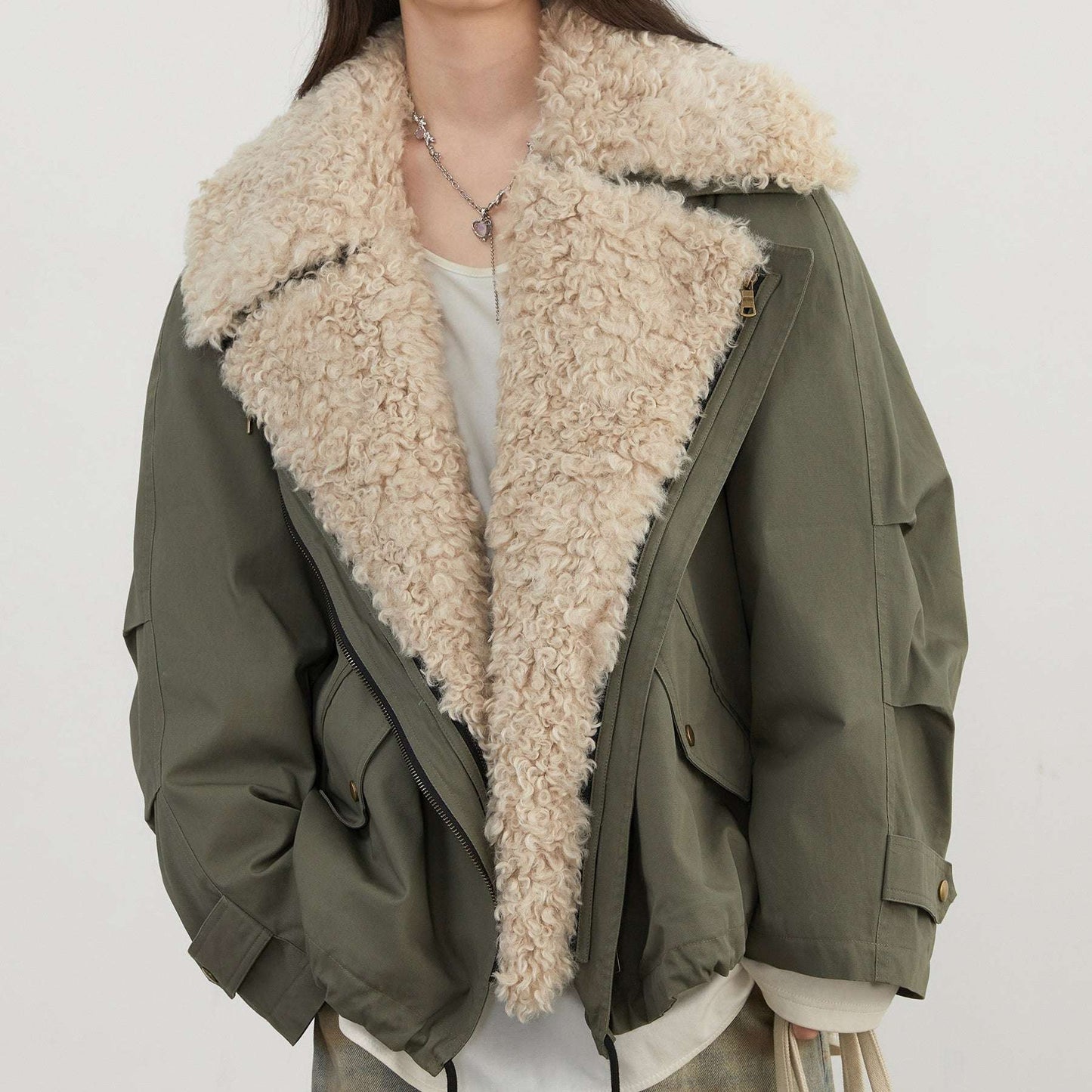 Green jacket with beige sherpa lining on a white background