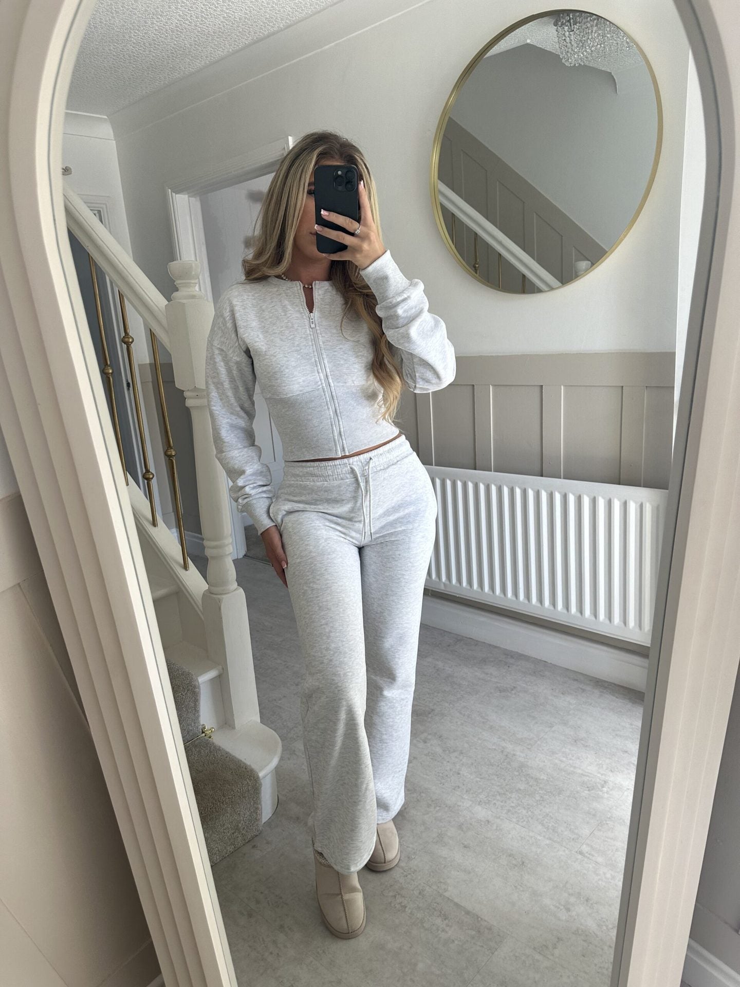 Women’s zip-front sweatshirt and jogger set in light gray, two-piece outfit.