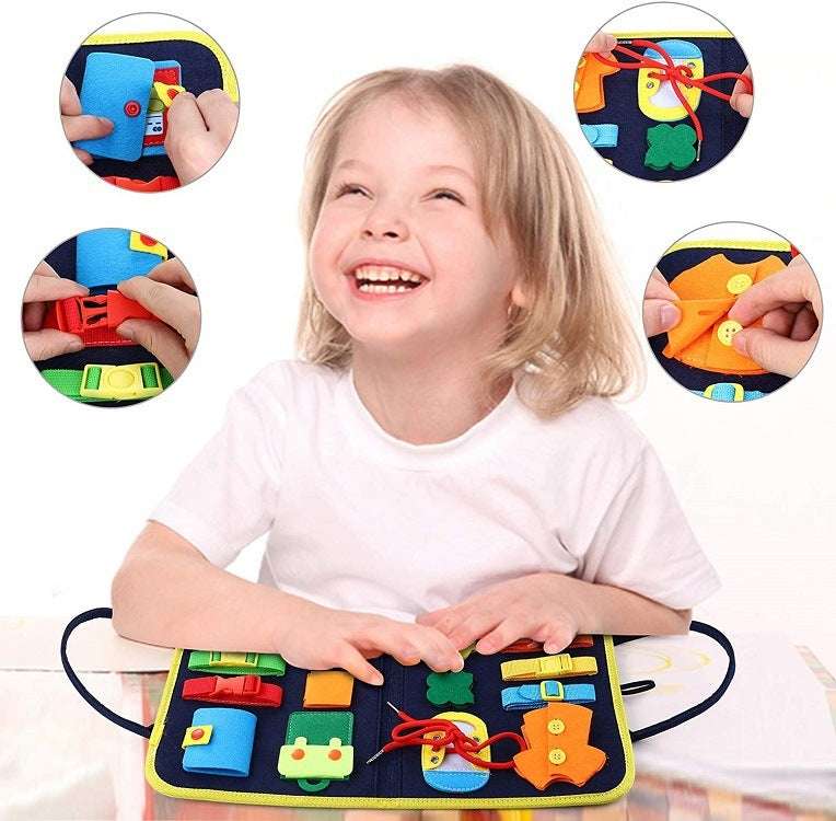 Child playing with a colorful educational mat with various shapes and letters.