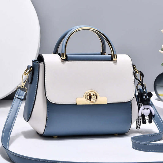 Lightweight crossbody bag with white and blue colorblock, top handle, flap, gold clasp