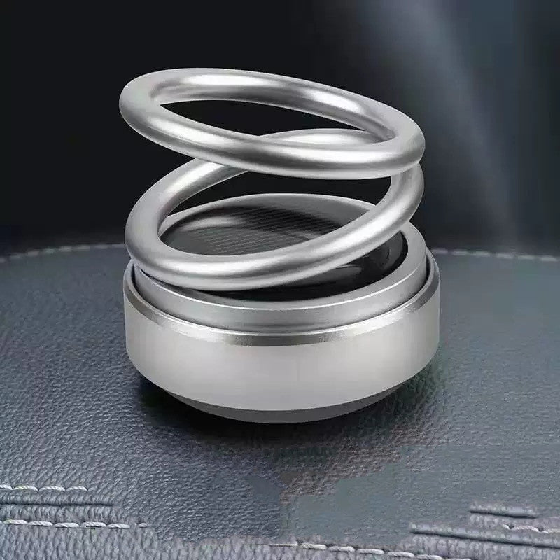 Metallic spring on a textured surface with a dark background
