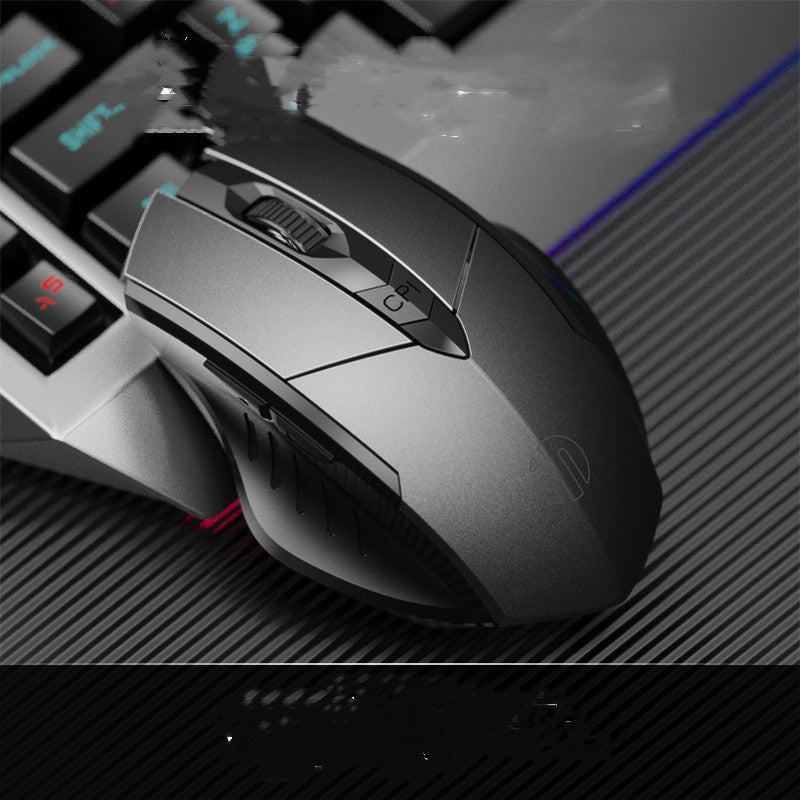 Gaming mouse on a desk with keyboard in the background