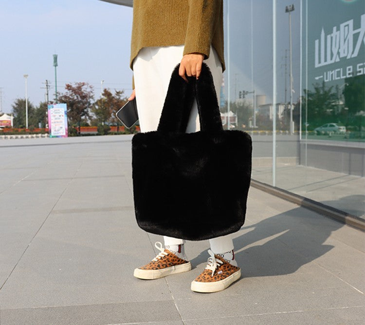Faux-fur tote handbag, black plush texture with short handles