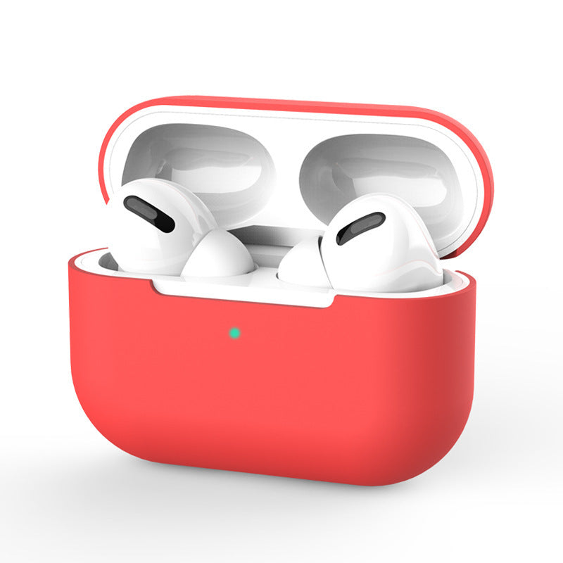 White wireless earbuds in a red charging case on a white background