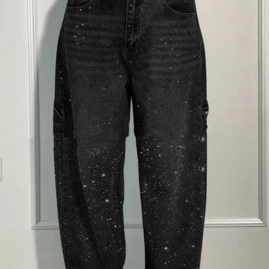 Black jeans with starry pattern against a neutral background