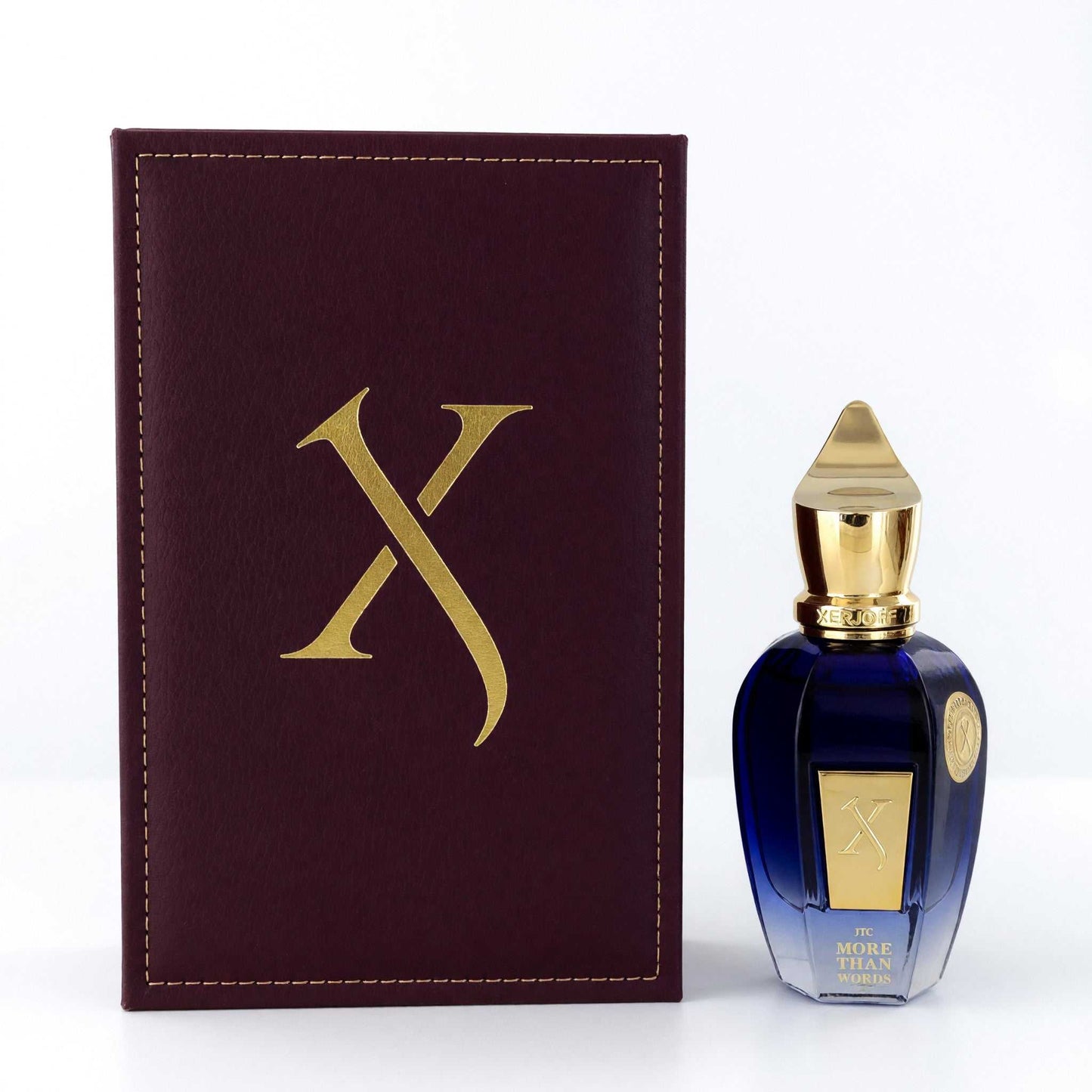 Unisex EDP spray bottle with blue glass and gold cap, shown with burgundy logo box