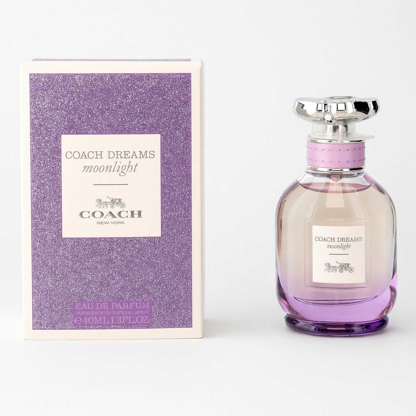Women's eau de parfum spray with clear glass bottle, pink-purple liquid, and purple glitter box.