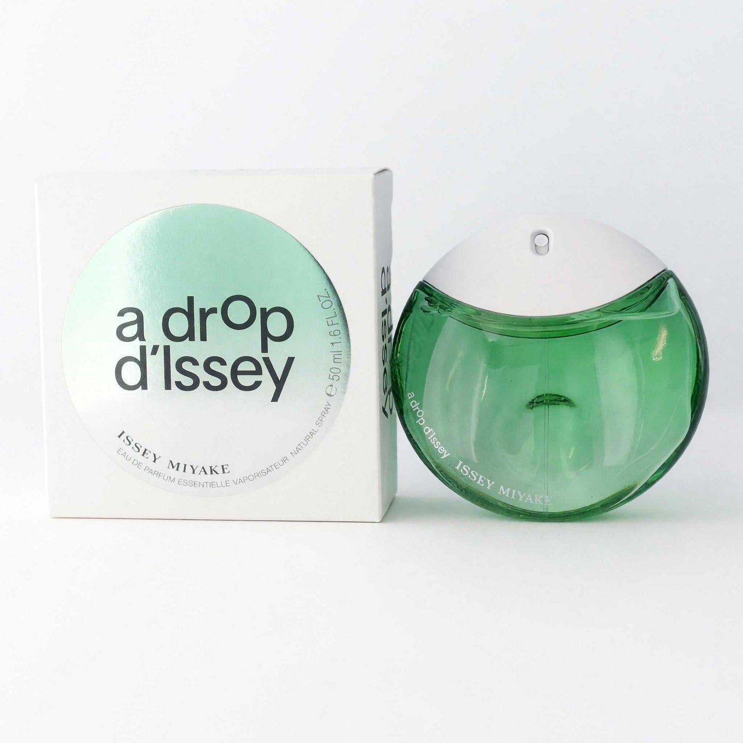 Women’s eau de parfum spray bottle with green curved glass and matching box