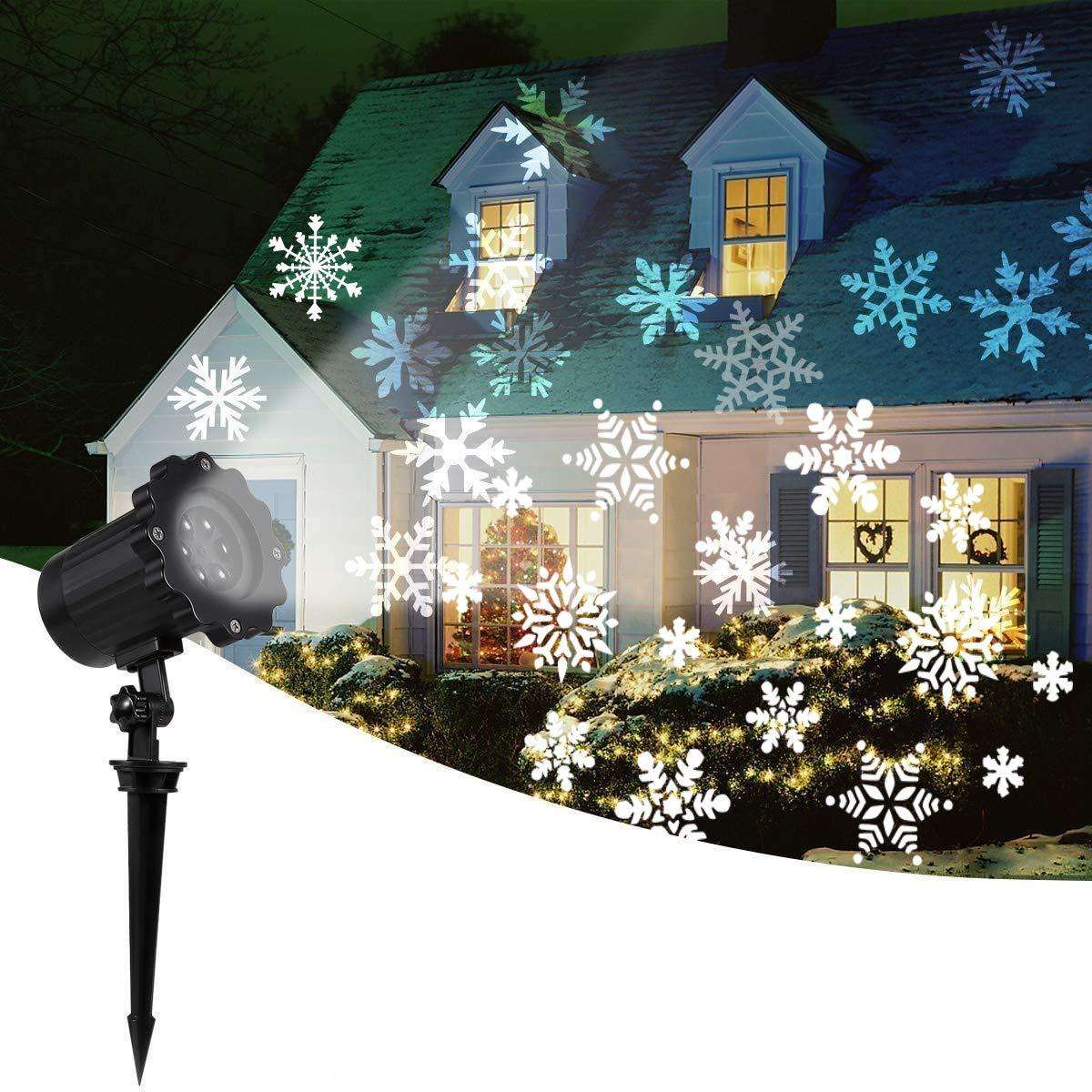House with snowflake projections and a Christmas light display, featuring a snowflake projector.