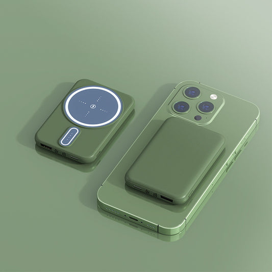 A green Magnetic Suction Charging Bank attached to a smartphone, showcasing its magnetic charging feature.
