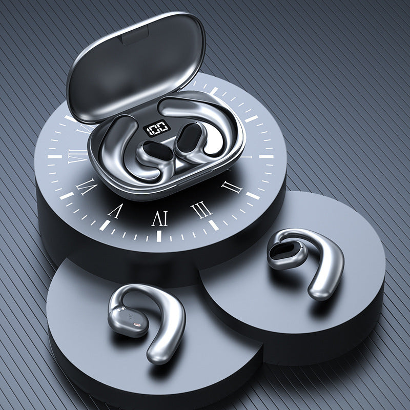 Silver wireless earbuds with charging case on a gray background