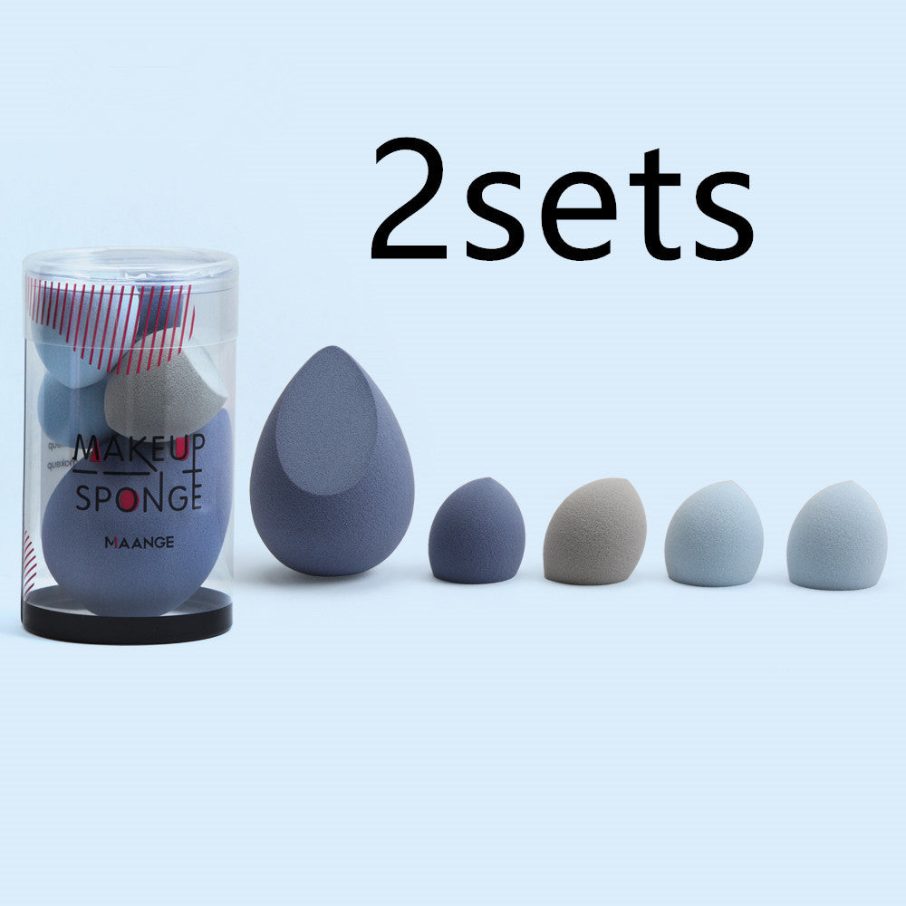 Set of makeup sponges with a container labeled 'MAKEUP SPONGE' on a light blue background.