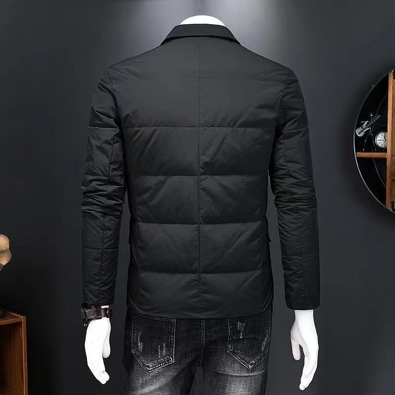 Black puffer jacket on a mannequin against a dark background