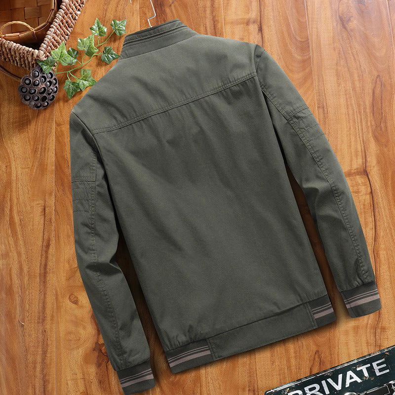 Green jacket on a wooden surface with decorative elements.