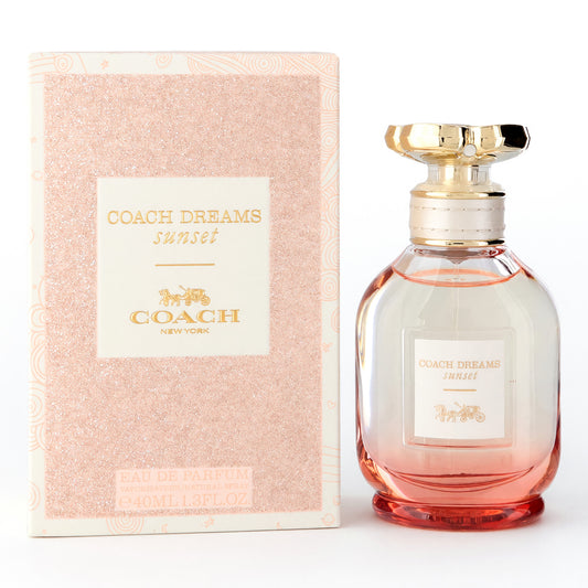 Women’s EDP spray bottle with gold cap and pink-orange glass, with matching box