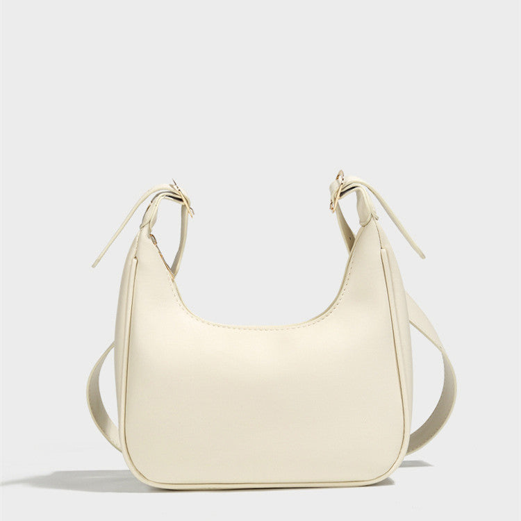 Cream dumpling crossbody bag with U-shaped opening and short shoulder strap ties
